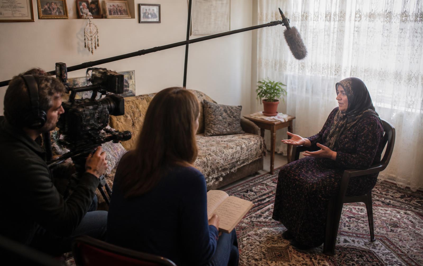 A documentary crew interviewing a woman in her living room